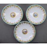 An early 20thC Minton porcelain dessert service, decorated with landscapes, cartouches,