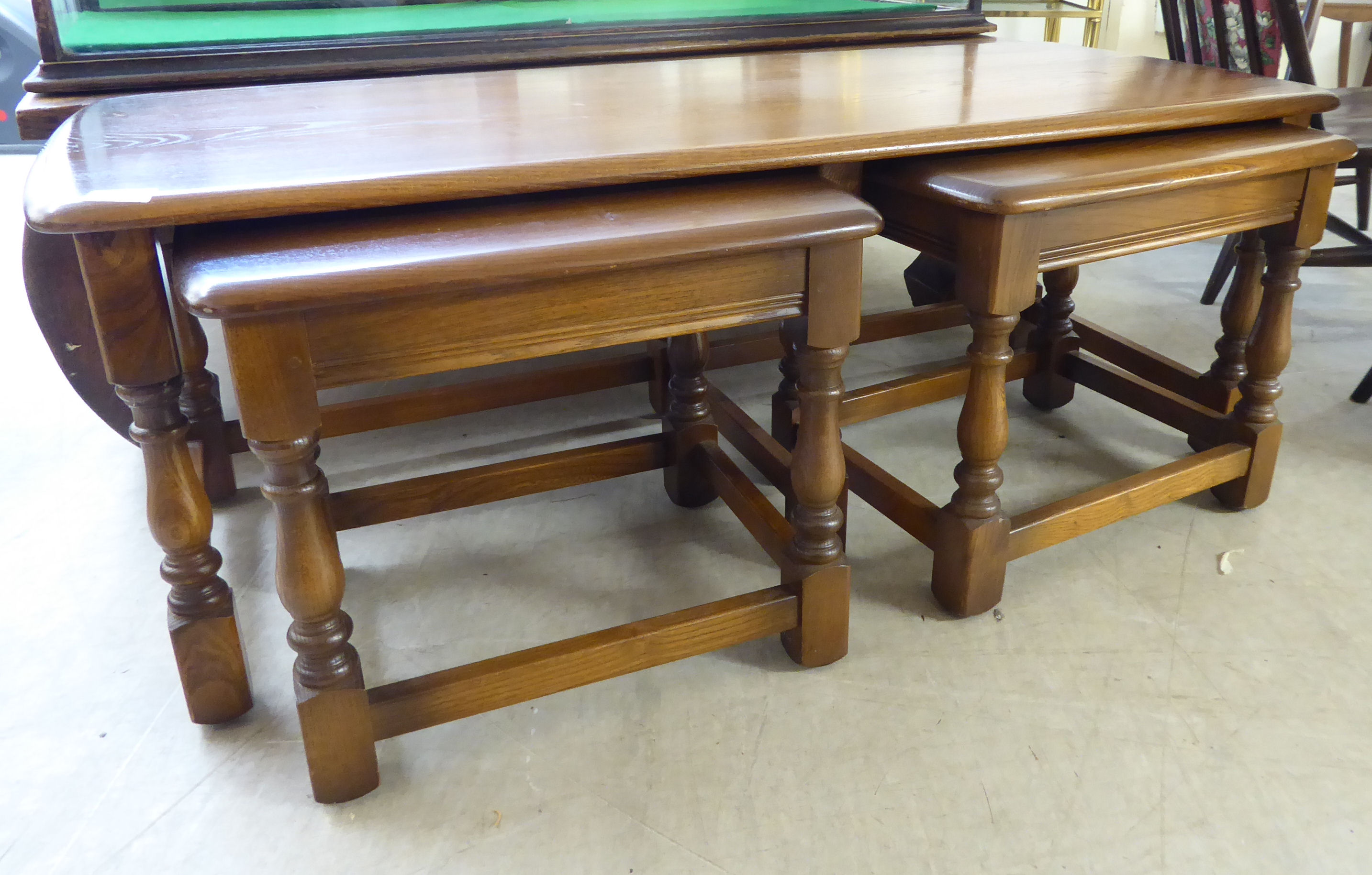 A nesting set of three Ercol Golden Dawn beech and elm occasional tables,