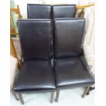 A set of four black vinyl upholstered dining chairs, raised on square,