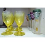 A set of six early 20thC tinted yellow stemmed wine glasses,