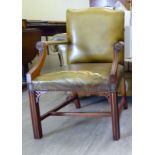 A modern Gainsborough style mahogany finished desk chair, stud upholstered in green hide,