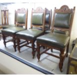 A set of six Edwardian oak framed dining chairs, each with a shell carved crest,