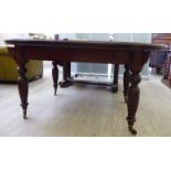 A late Victorian mahogany dining table,