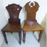 Two similar mid Victorian mahogany panelled back hall chairs, each with a solid seat,