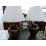 A pair of modern pottery table lamps of baluster form with a textured gold finish 22''h and cream