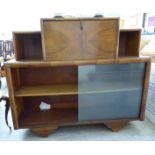 An Art Deco mahogany finished bookcase with a staggered breakfront top,