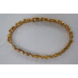 A yellow metal chain link bracelet stamped 9ct 11