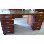 A modern yew wood finished twin pedestal, nine drawer desk,