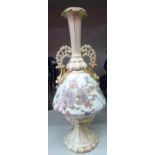 A late Victorian German porcelain vase with opposing handles, decorated with flora,