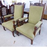 A pair of Edwardian oak framed salon chairs, upholstered in a green fabric,