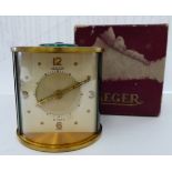 A Jaeger brushed lacquered brass drum cased traveller's timepiece; the 8 day movement with an alarm,