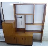 A modern laminated teak effect living room unit with a staggered arrangement of open shelves and