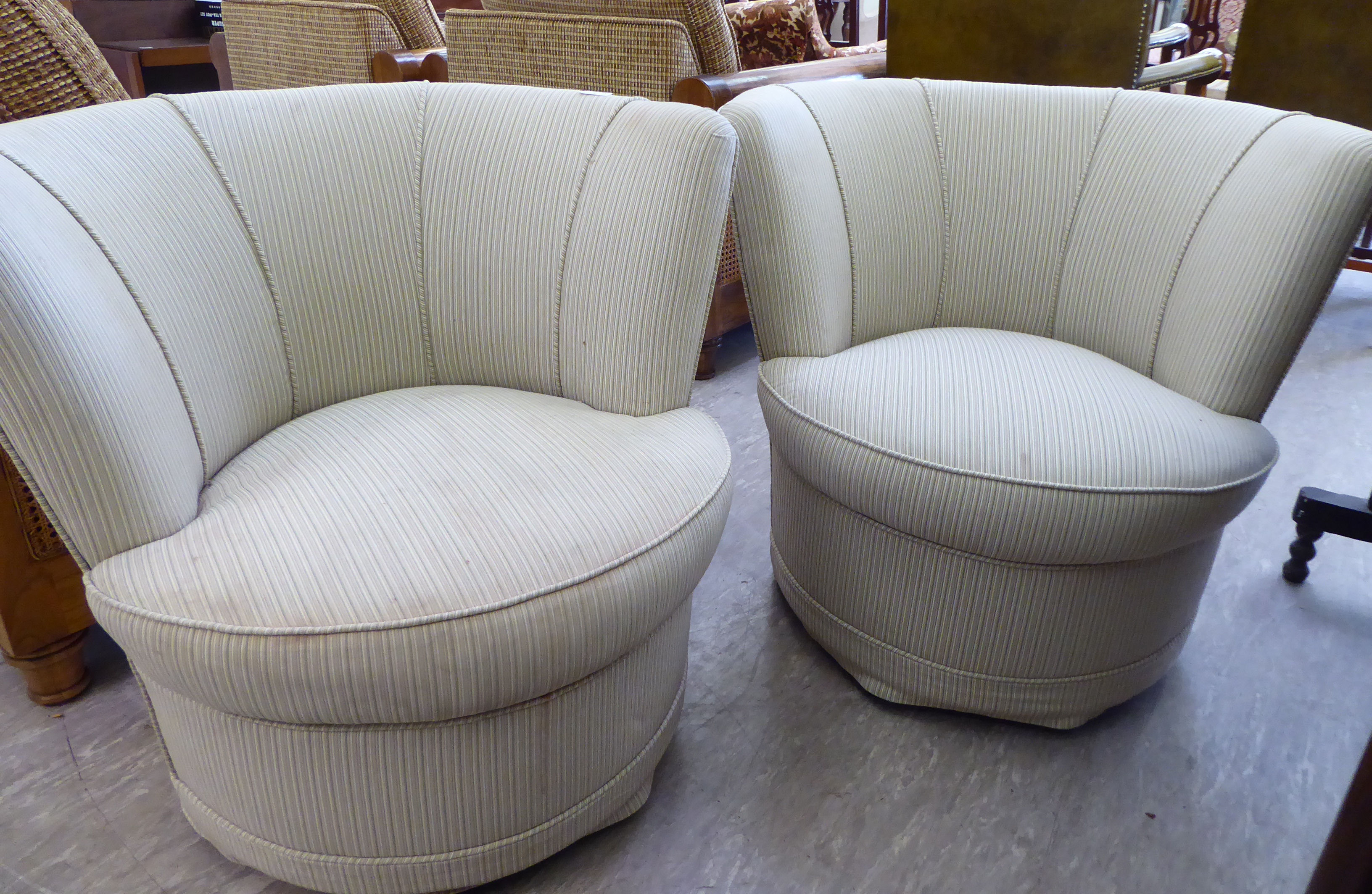 A pair of modern tub design bedroom chairs, each with a fan shaped back,