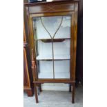 An Edwardian satinwood inlaid mahogany display cabinet with a single, glazed door,