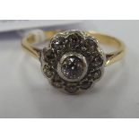 An 18ct gold and platinum diamond cluster ring 11