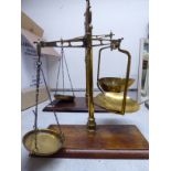 A set of Victorian brass balance scales with a tubular column and two pans,