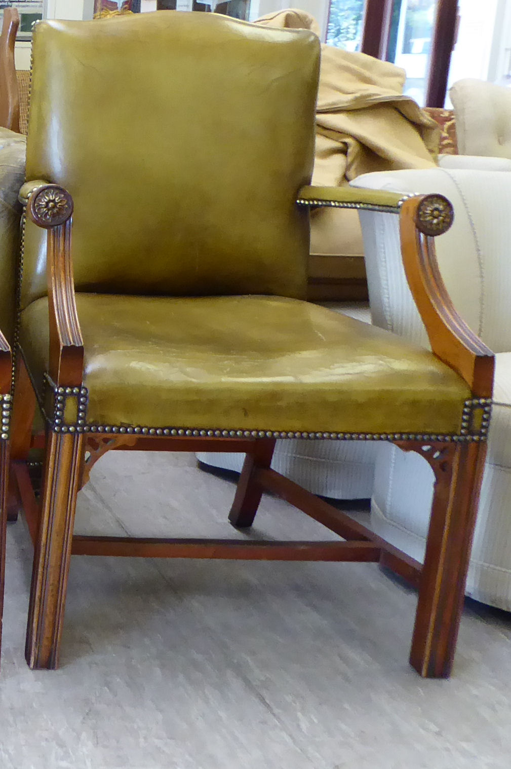 A modern Gainsborough design mahogany finished desk chair, stud upholstered in green hide,
