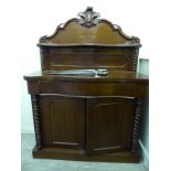 A late Victorian mahogany chiffonier with a raised back, over a frieze drawer and two doors,