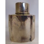 A late Victorian silver tea caddy of shouldered serpentine outlined form with a capped cover ES