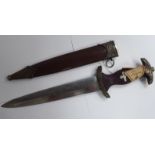 A German SA dagger, the moulded wooden handle with decorated mounts and emblems,