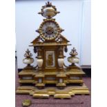 A late 19thC French classically inspired, ornately cast gilt metal and grey onyx mantel clock,