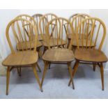 A set of eight Ercol beech and elm framed hoop and spindled back dining chairs,