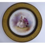 An early 20thC French porcelain plate, featuring a couple,