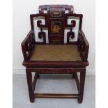 A 19thC Chinese lacquered and carved elm framed open arm chair, the back with sandalwood decoration,