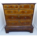 An early 18thC string and feather inlaid walnut chest with figured panels in a variety of wood