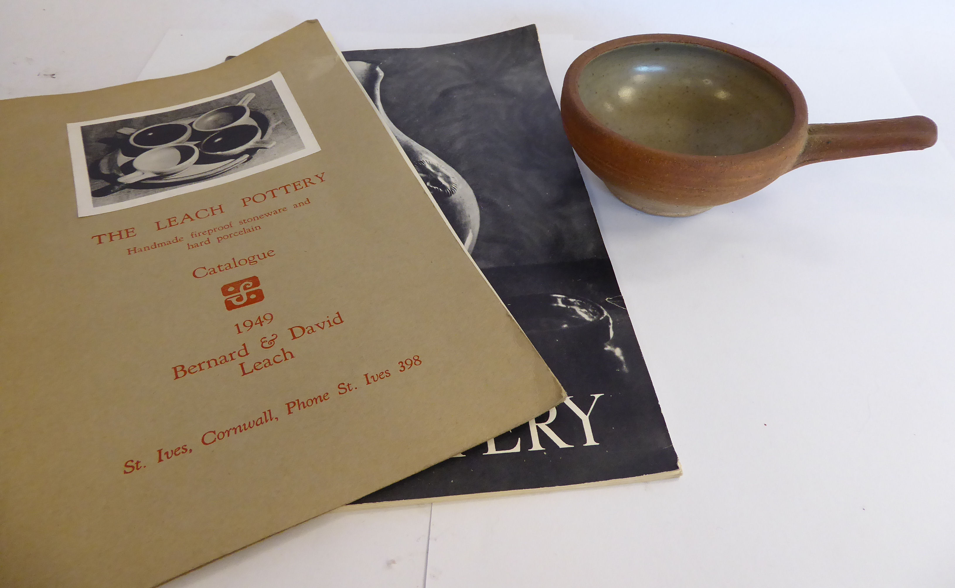 A Leach Pottery naturally coloured stoneware and celadon glazed hard porcelain egg baker or ramekin