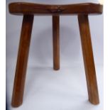 A Robert 'Mouseman' Thompson honey coloured oak stool, the dished,