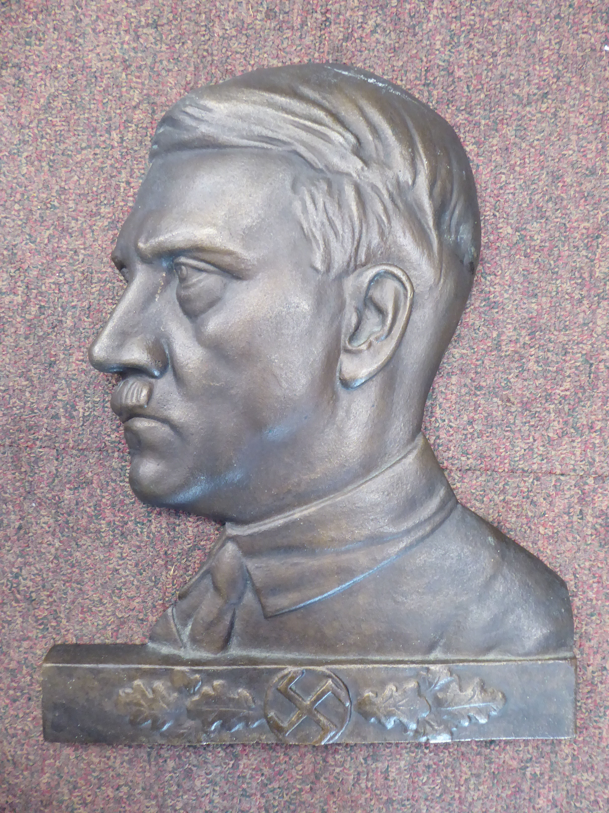 A bronze finished cast iron profile portrait plaque,