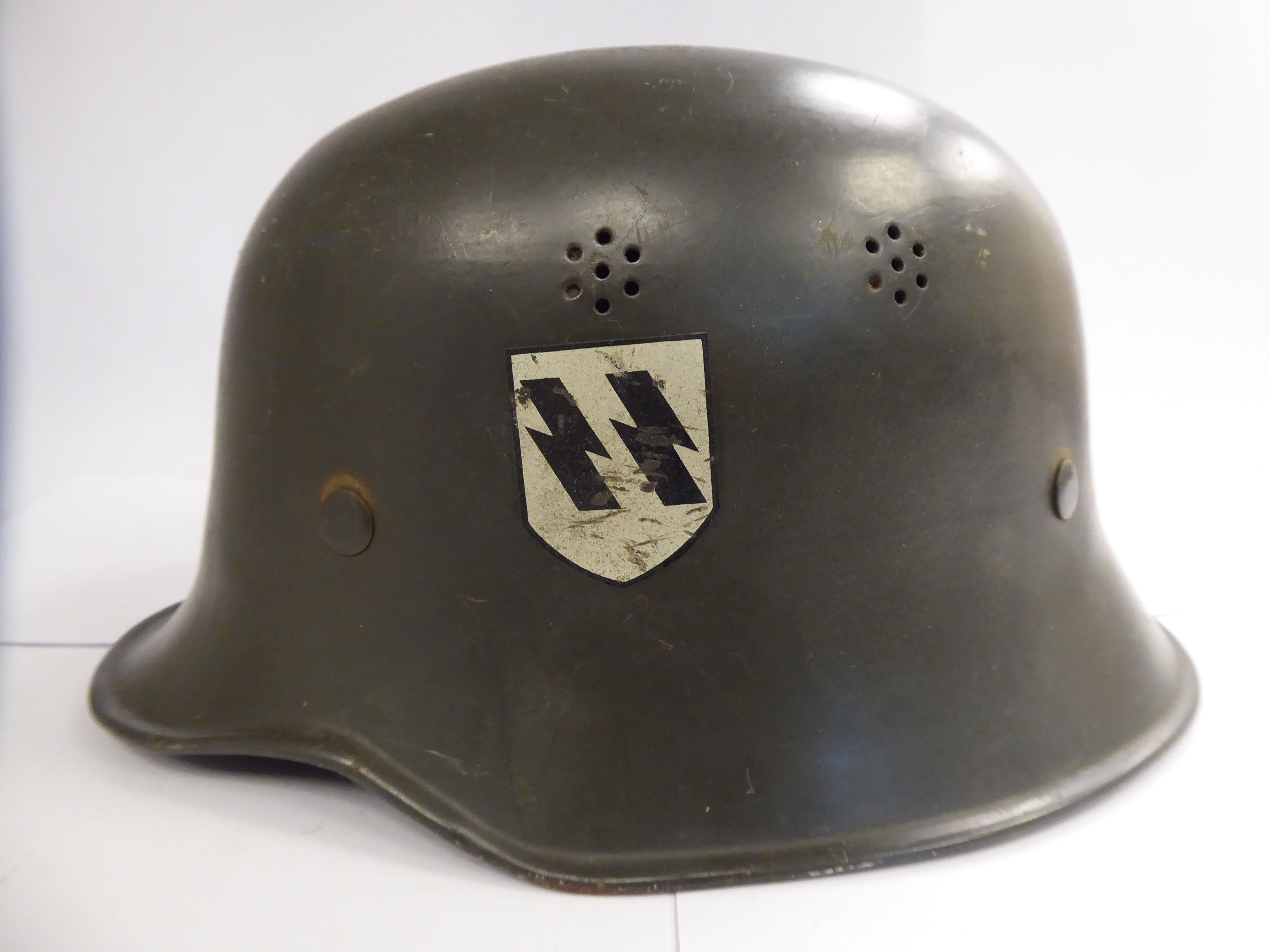 A German green painted SS helmet with a hide lining and decals (Please Note: this lot is offered - Image 3 of 8