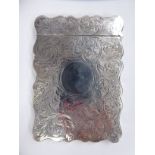 A Victorian silver card case of serpentine outline with a hinged cap,