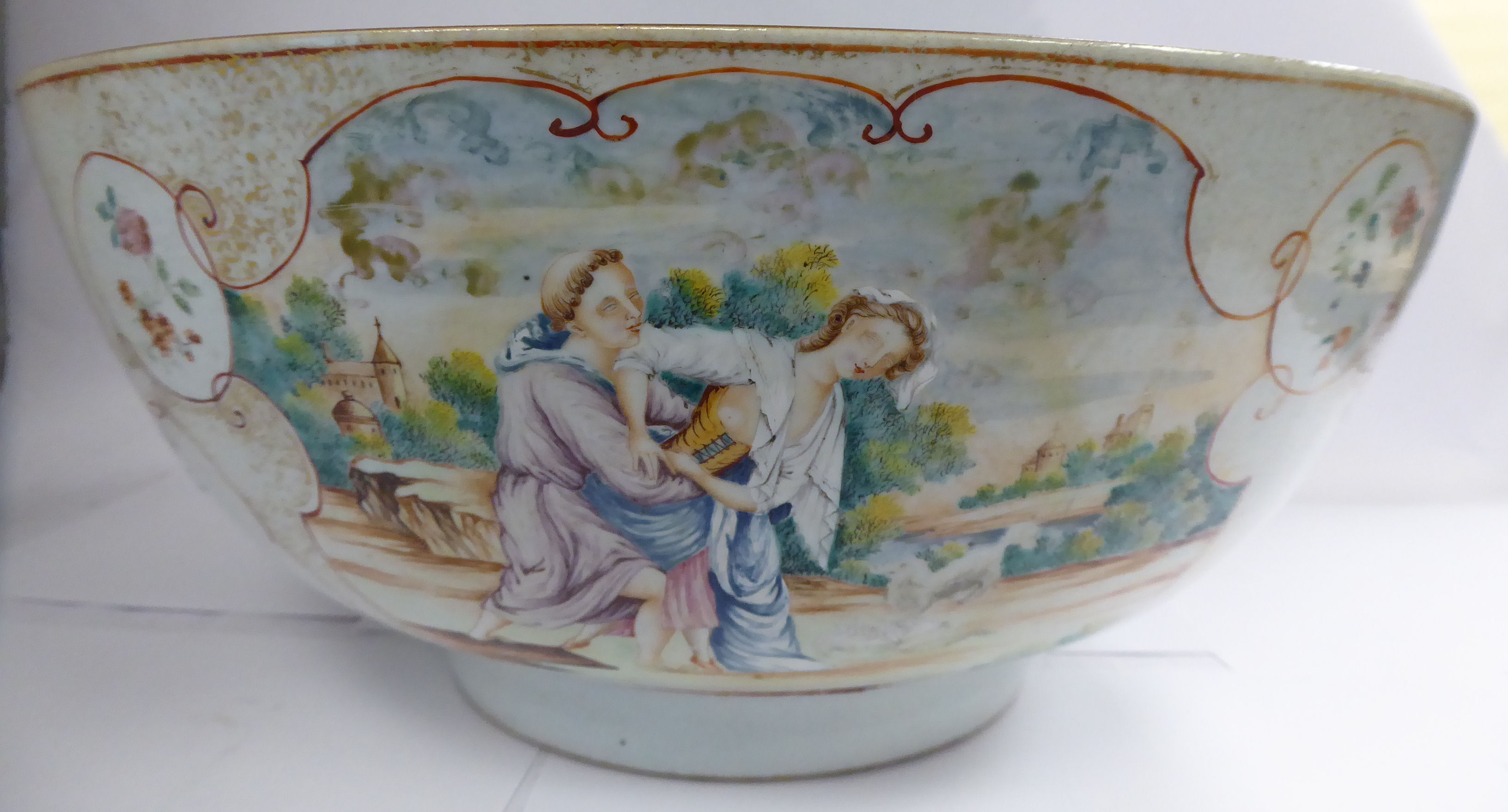 A late 18thC Chinese porcelain footed bowl, decorated in European taste in reserves with figures,