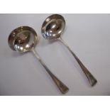 Two similar George III silver bead bordered sauce ladles with oval bowls mixed marks London 1805