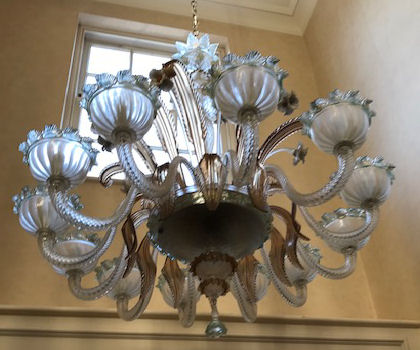 A Murano twelve branch opaque glass chandelier with a floral encrusted central column and