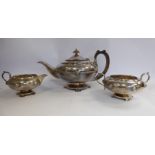 A three piece silver tea set of Celtic inspiration, comprising a teapot of squat,