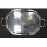 A silver serving tray of elongated octagonal form with a raised,