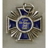 A German military silvered metal and blue enamel medal, featuring a cross,