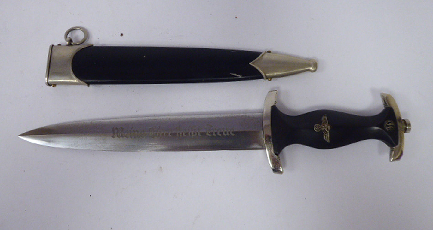 A German SS dagger, the ebonised handle with emblems,