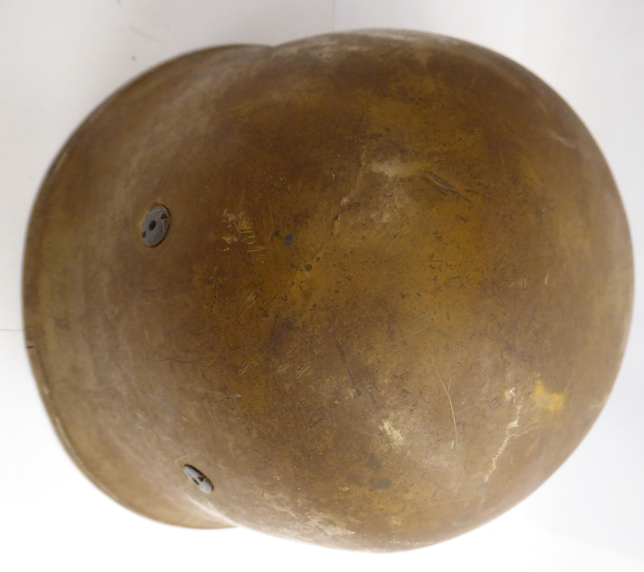 A German brown painted parachutist's helmet with a hide lining and chinstrap (Please Note: this - Image 4 of 8