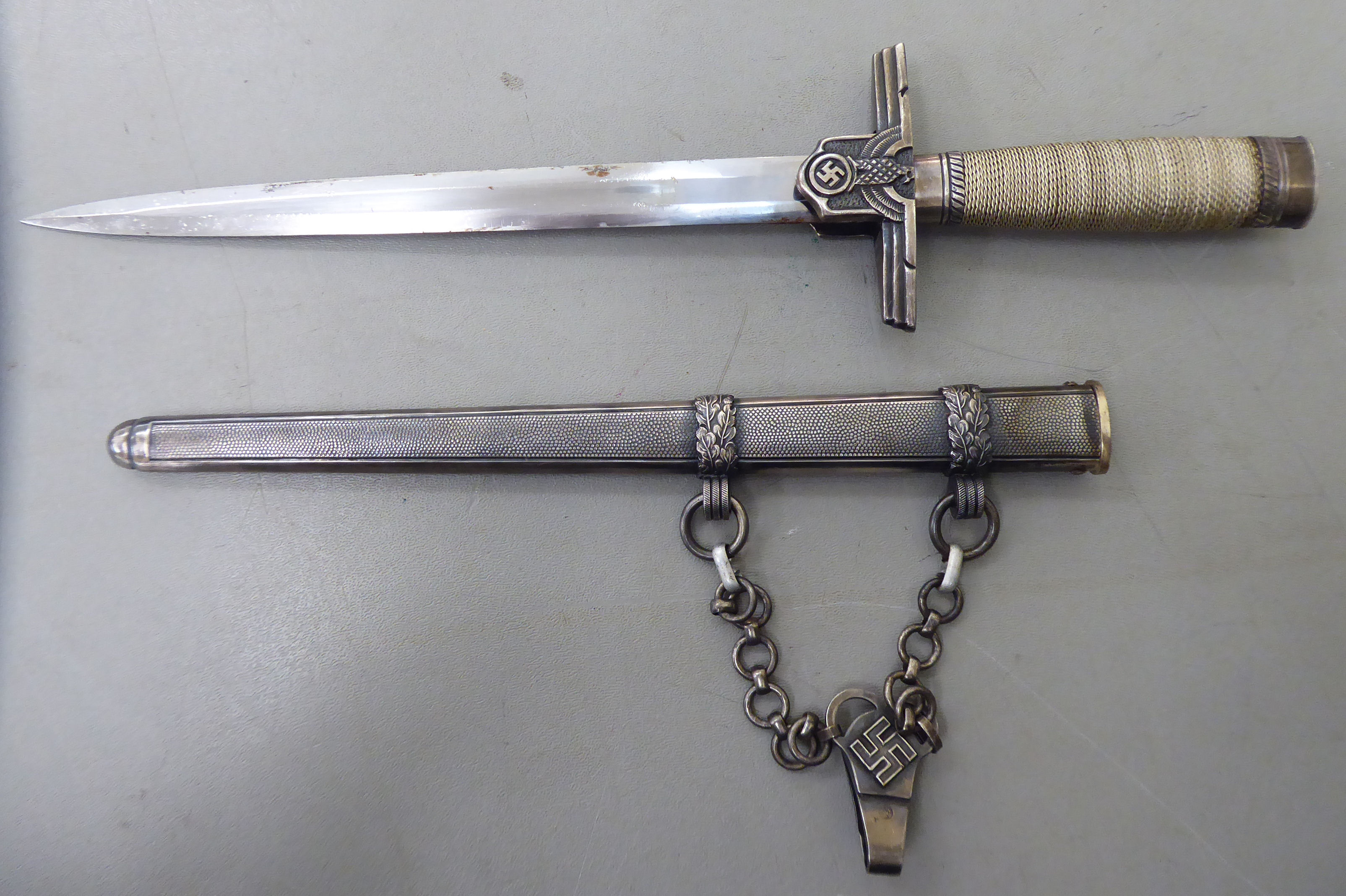 A German Hitler Youth Leader dagger, the wire bound handle with emblems on the crossguard,