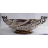 A late Victorian silver bowl of shallow, oval form, decorated with wrythen moulded,