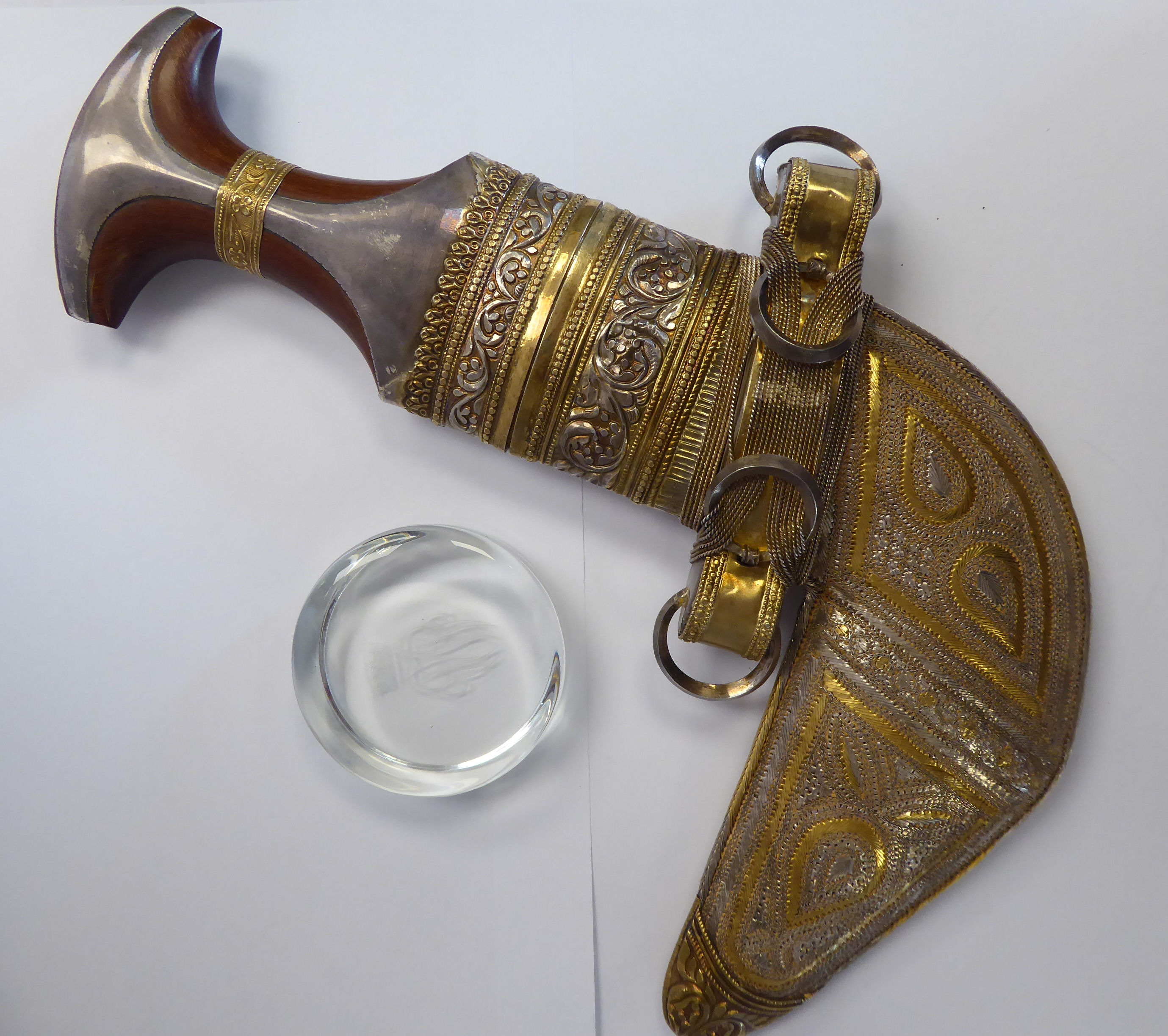 An Omani Khanjav dagger, the wooded handle with overlaid bi-coloured metal ornament,