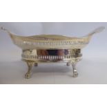 An Edwardian silver oval sweet dish with pierced sides and a wide, wavy edge,