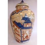 A late 18th/early 19thC European Delft vase of baluster form, having a cover and finial,