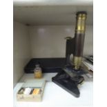 A Beck of London mid 20thC brass and cast iron microscope, model no.