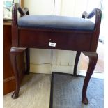 An early 20thC mahogany framed piano stool with a hinged seat,