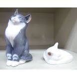 Royal Copenhagen porcelain, viz. a seated cat no.115 5.25''h; and a sleeping kitten no.